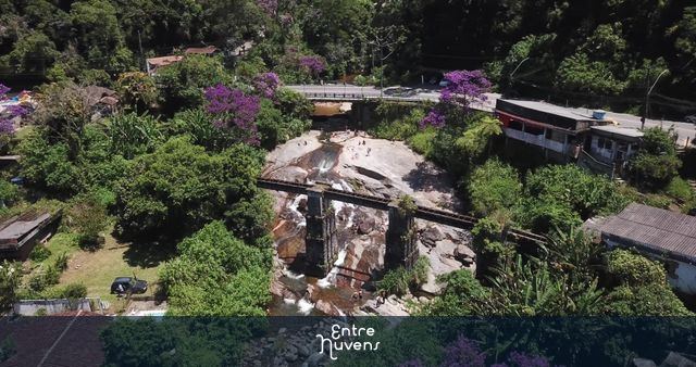 Banhistas no rio Paquequer sob as ruinas da antiga ferrovia e entrada do Parque Nacional da Serra dos Órgãos — vídeo aéreo de Teresópolis