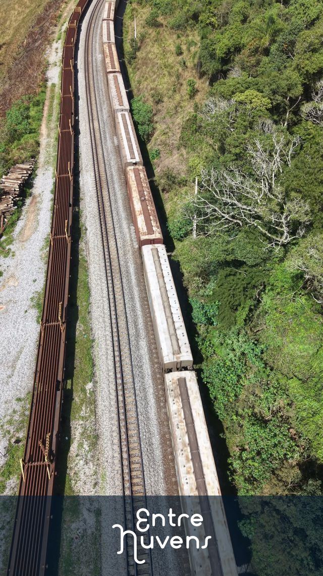 Trem de carga serpenteando por uma ferrovia em meio à natureza exuberante — vídeo aéreo de Cotia